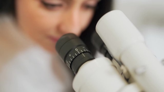 female gynecologist doctor closeup on microscope