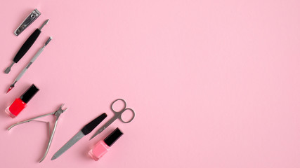 Manicure and pedicure tools on pink background, view from above. Nail salon banner design template....