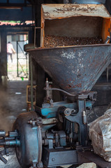 Old and vintage coffee grinder at a coffee mill in Malaysia.