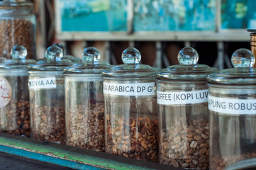 Coffee beans selection from various countries on display on the table.