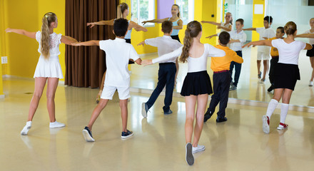 Children learn dance movements in dance class