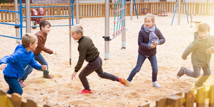 Children playing tag on playground