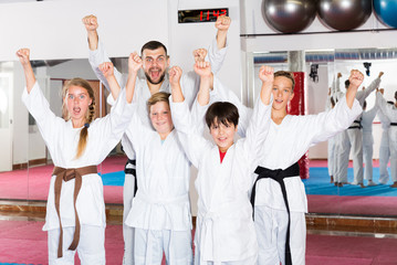 Happy kids karate group with coach