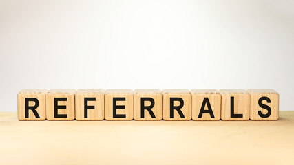 REFERRAL word made with wooden blocks concept
