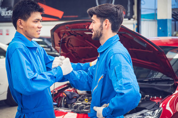 Mechanics working in the workshop garage. Team work concepts