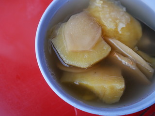 Dessert of boiled potatoes in ginger water