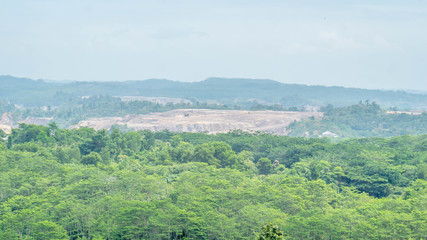 Fototapeta na wymiar Open pit coal mining surrounded by tropical rain forest in Samarinda, Borneo, Indonesia. Ecological and environmental issue