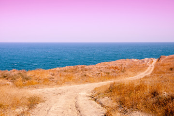 Sea nature landscape. View of the sea from the mount. The country dirt road along the sea