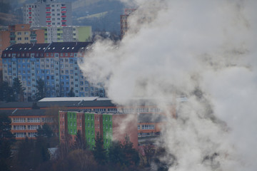 Smoke from the chimney of the thermal power plant rises above the city and pollutes nature
