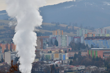 Smoke from the chimney of the thermal power plant rises above the city and pollutes nature