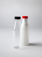 Two bottles - made of transparent and white plastic