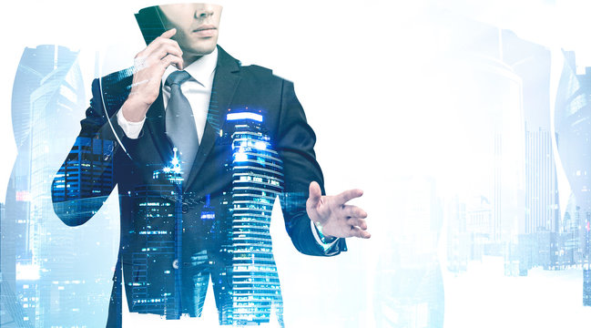 Businessman talking on smartphone in city