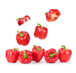 Flying red sweet peppers isolated on white