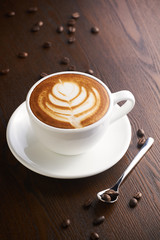 Cup of latte or Cappuccino on table in cafe.