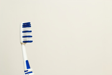Close up of a toothbrush with blue bristles on white background