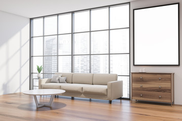 White living room corner with sofa and poster