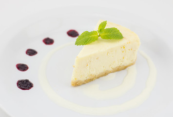 cheesecake with mint leaf and jam on white background