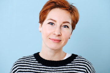 Portrait of a middle aged woman with short ginger hair.