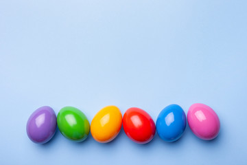 Flat lay composition made with Easter eggs on color background. Top view  with place for text