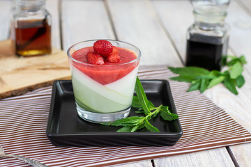 mint vanilla panna cotta with strawberry sauce in glass