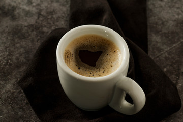 Cup of coffe Cappuccino  with milk on a dark background. Hot coffe ,latte or Cappuccino prepared with milk on a wooden table with copy space.