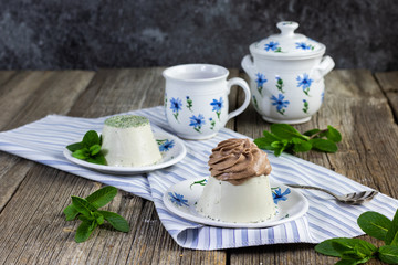 mint panna cotta with chocolate cream set on a old table