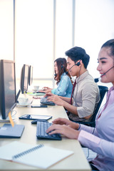 Fototapeta premium Group of young teamwork businesspeople with headset and computer at office.