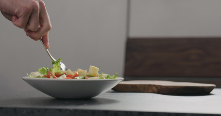 man eat salad in white bowl