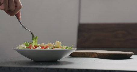 man eat salad in white bowl