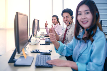 Group of young teamwork  businesspeople Thumbs up with headset and computer at office.