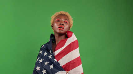 Beautiful joyful black african sexy young women.Cheerful girls dancing with the flag of America in their hands in honor of Independence Day.
