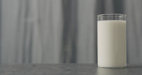 white yogurt in glass on concrete countertop