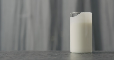 white yogurt in glass on concrete countertop