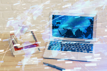 Double exposure of desktop computer and technology theme hologram. Concept of software development.