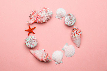 Summer time concept with sea shells and starfish on trendy Living Coral pastel color background, copy space. Flat lay, top view