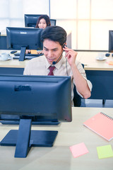 Young customer service men agent with headsets and computer working at office.