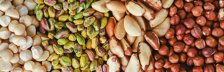 Mix nut wide banner or panorama. Natural healthy food background made from different kinds of nuts.