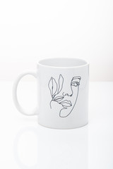  white cup with an inscription and a pattern on a white background