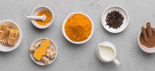 Coconut milk with turmeric in a jar on concrete background