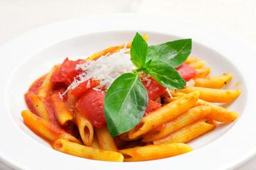 Italian pasta with tomato sauce and basil