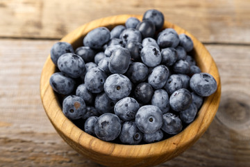 Fresh blueberries in a wooden bowl.