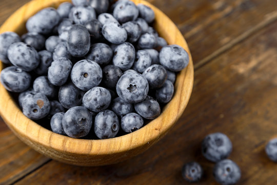 Fresh blueberries in a wooden bowl.