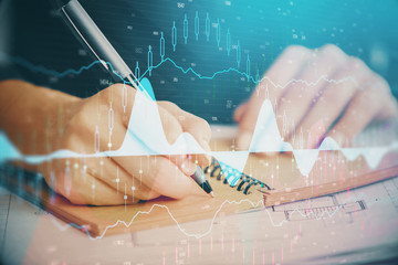 Forex chart displayed on woman's hand taking notes background. Concept of research. Double exposure