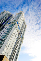high-rise and residential building on sky background
