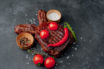 Grilled Easter steak with spices. Easter bunny on stone background with copy space for your text.