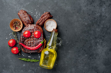 Grilled Easter steak with spices. Easter bunny on stone background with copy space for your text.