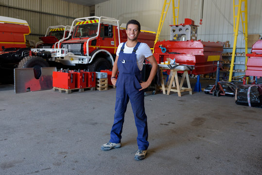 young male firetruck mechanic posing