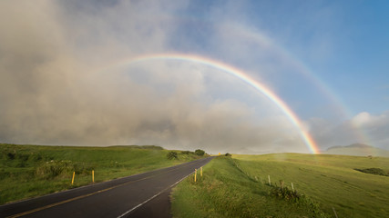 road to the rainbow over field and clouds in Hawaii