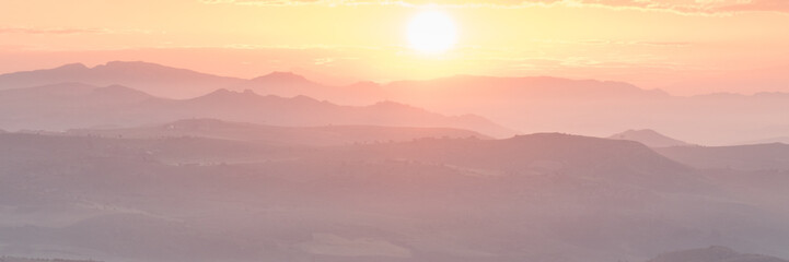 sunset on mountains with horizon
