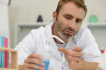 male researcher holding a test tube in the lab